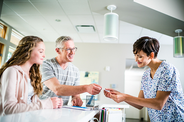 A patient talking to a nurse in a clinical setting